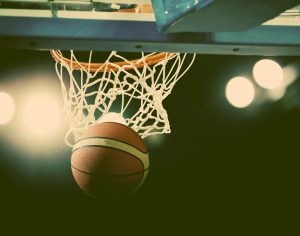 Basketball going through the hoop at a sports arena