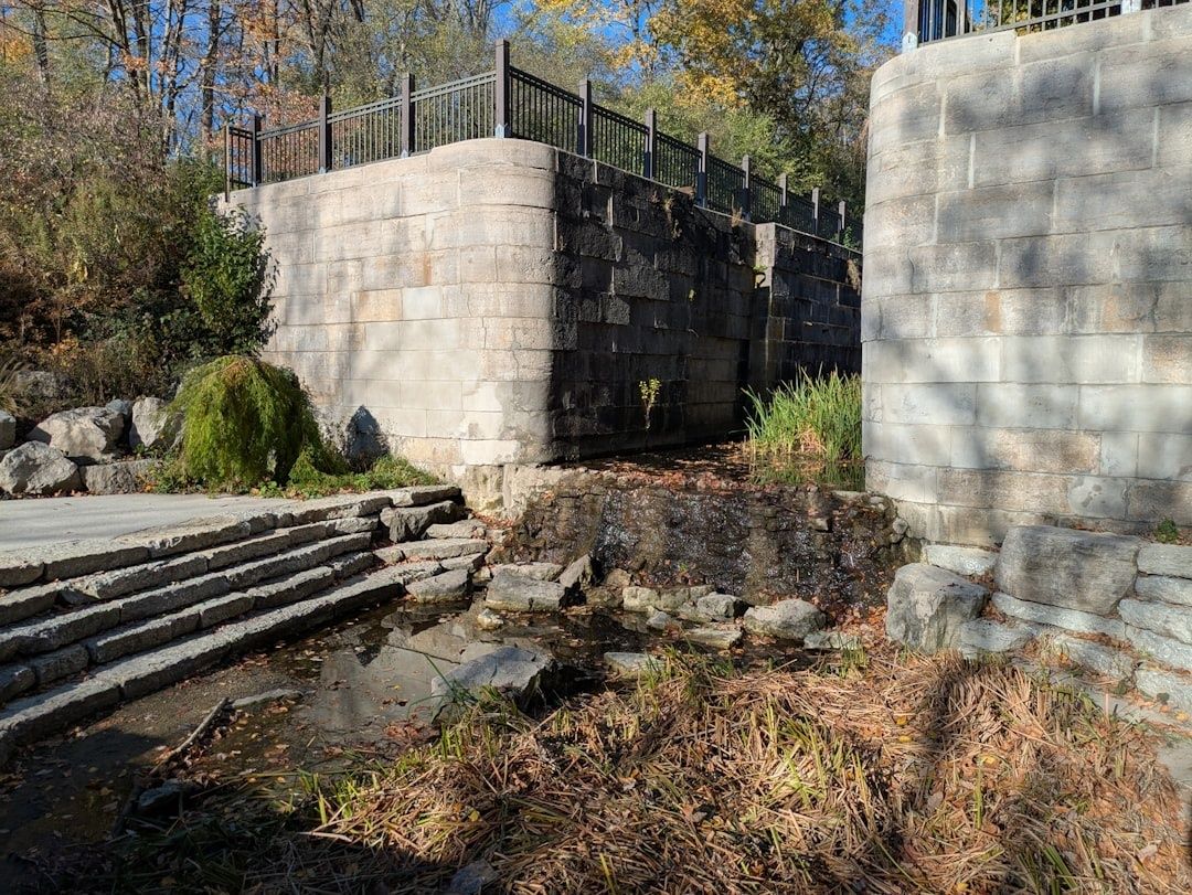 Stone canal lock ruins with a small cascading watercourse and railings